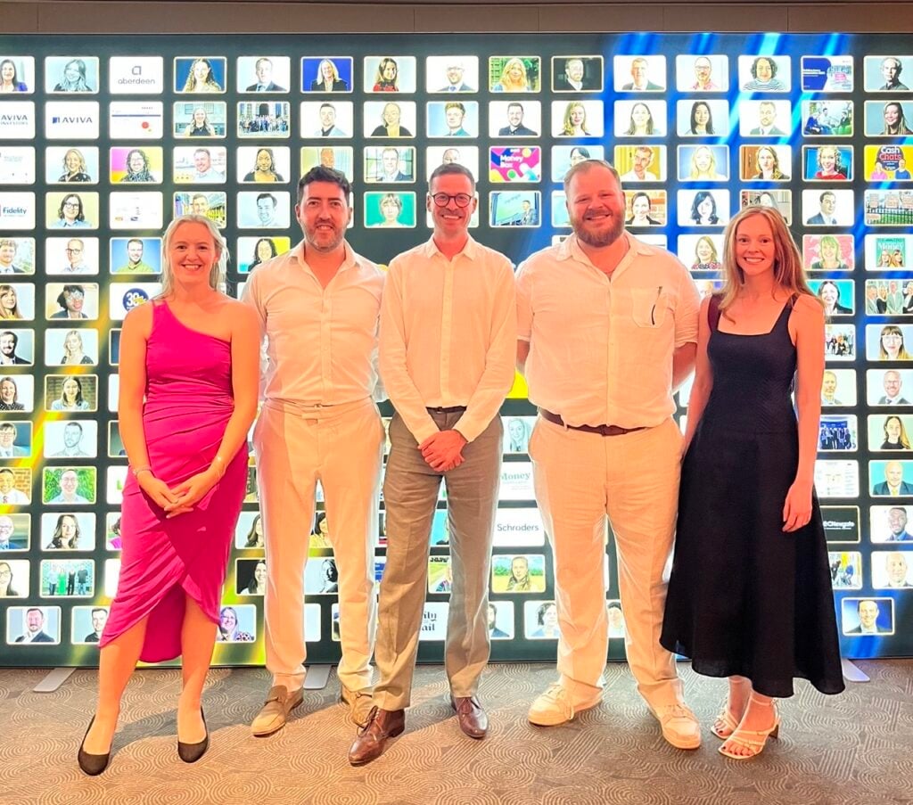 The City Road Communications team standing in front of the illuminated Headline Money Awards 2025 backdrop